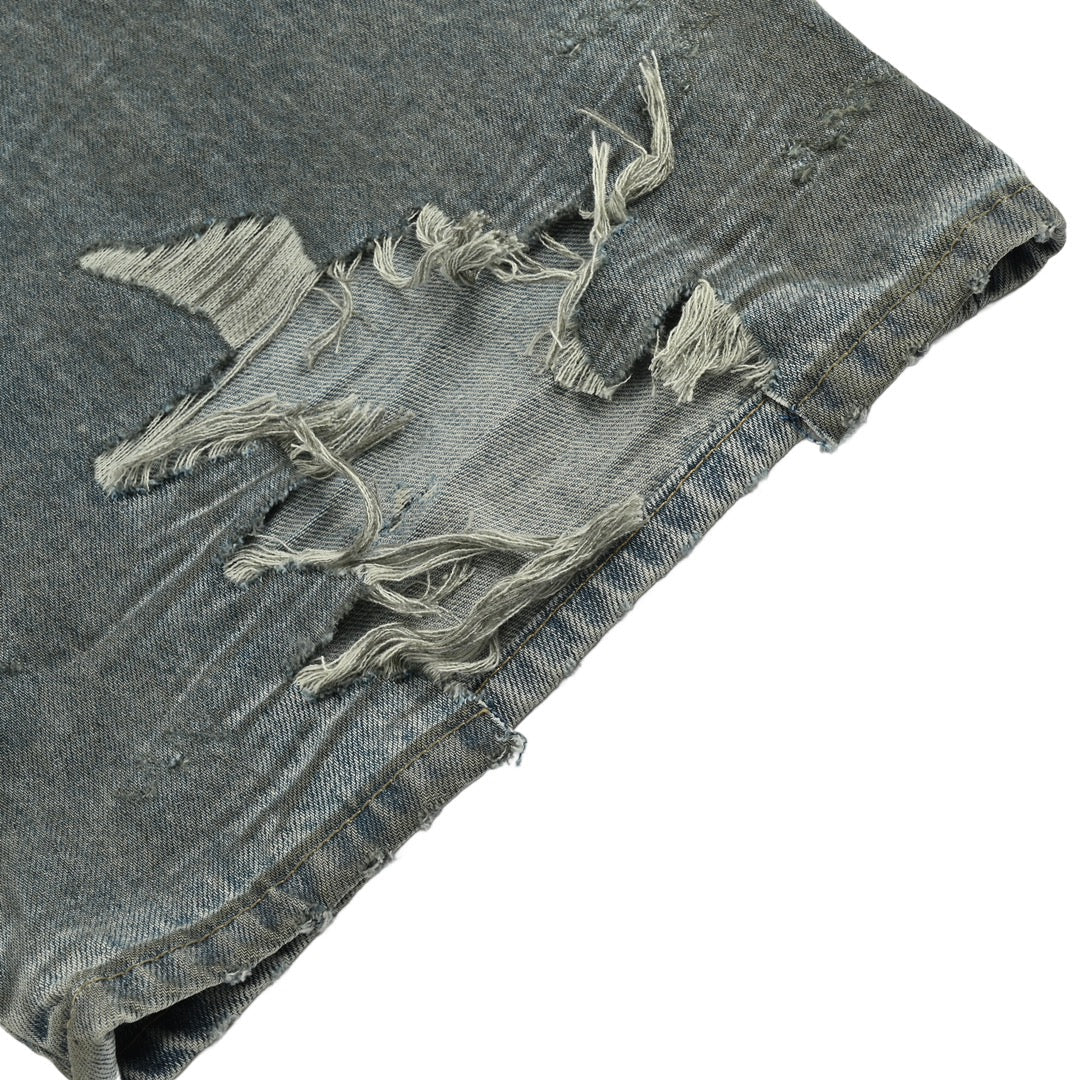 Mud-dyed distressed jeans